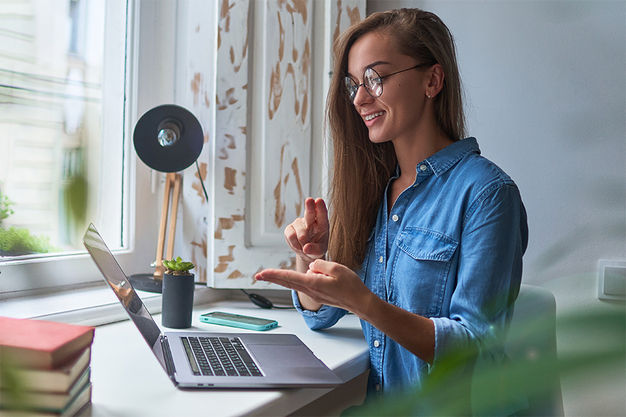 female signing into laptop