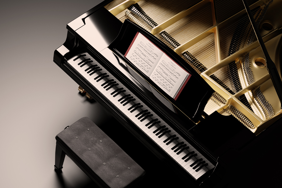 Overhead view of an open grand piano with sheet music on the stand and a bench beside it.