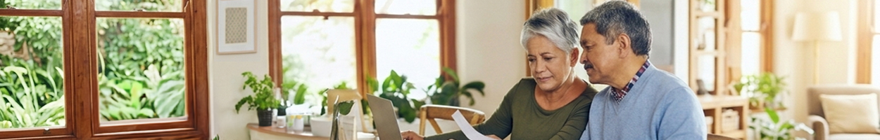 Adults in a workshop setting reviewing financial planning documents with an instructor.