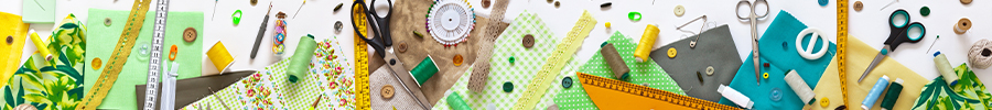 A colorful flat lay of sewing supplies including fabric, thread, scissors, and buttons. A colorful flat lay of sewing supplies including fabric, thread, scissors, and buttons.