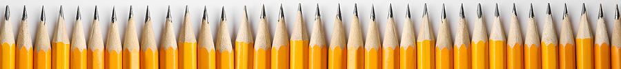A row of sharpened yellow pencils lined up side by side against a white background. A row of sharpened yellow pencils lined up side by side against a white background.